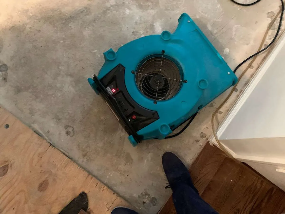 Air mover drying subfloor during Commercial Water Damage Restoration in Los Gatos